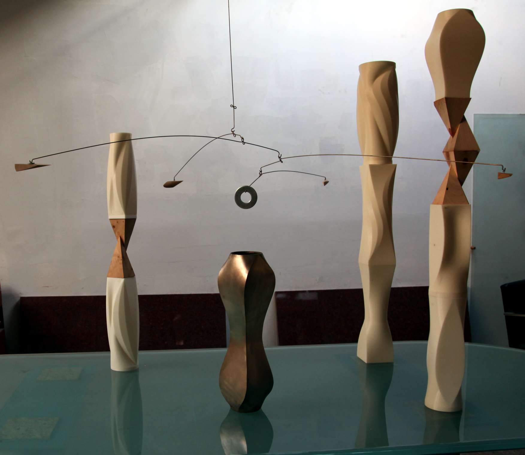 Abstract wooden sculptures and hanging mobile in a studio