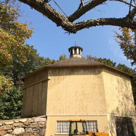 Shaker-style stone house on a hillside
